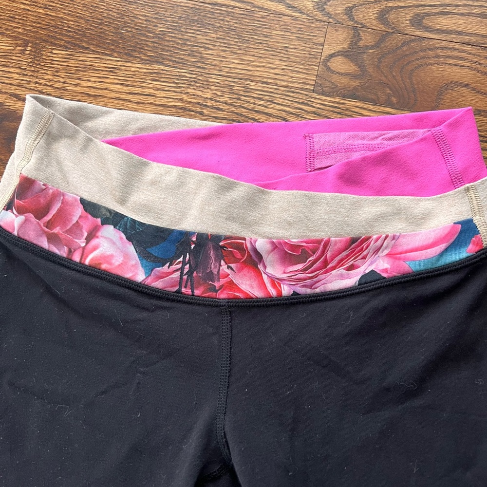 Lululemon black and pink and floral low rise long legging.